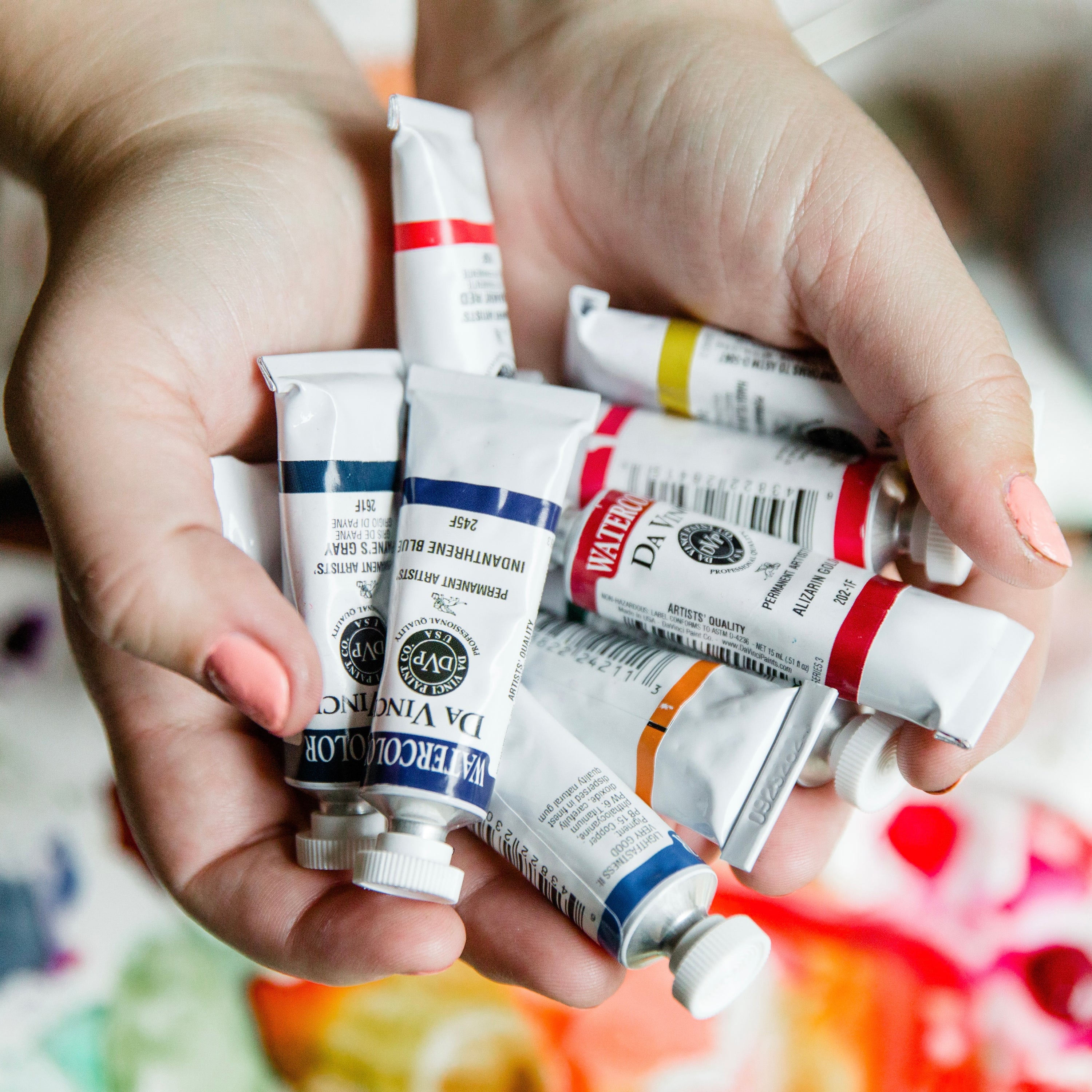 hands holding Da Vinci Professional Watercolor Paint Tubes